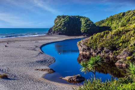 Pacific coast at low tide. Travel to the ends of the world. New Zealand, South Island. Road to Knight's Point Lookout is an unforgettable majestic landscapeの写真素材