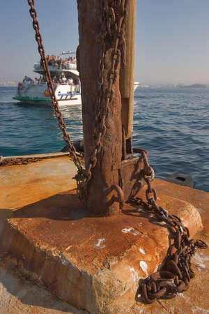 A rusty berthing curbstone on a pier of lock If and the swimming up shipの写真素材
