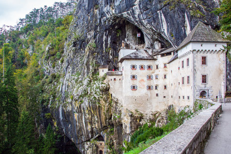 Old medieval castle in the park. Magical places in Slovenia. The famous and most visited place in the country by tourists. Postojna Cave on Limestone plateau.のeditorial素材