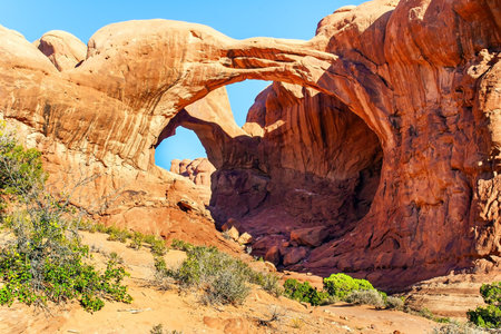 Double Arch. Picturesque red-brown sandstone cliffs form a unique landscape. Grandiose rock compositions natural origin. The beauty of Arches Park in USA.の写真素材