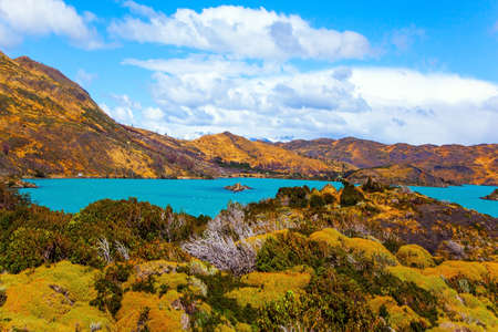 Huge lake with bright azure water from melting glaciers. Picturesque lake Pehoe in the Patagonian Andes. Travel to Chile. Cold and windy summers in the Southern Hemisphereの写真素材