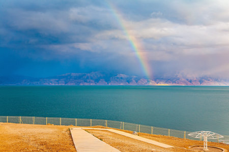 The gloomy sky with dark thunderclouds and rainbow. The Dead Sea. Israeli coast. The exotic thunderclouds  for treatment and relaxationの写真素材