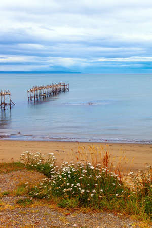 Strait of Magellan. The embankment and ruined ocean pier in Punta Arenas. The sky is covered with heavy thunderclouds. South Americaの写真素材