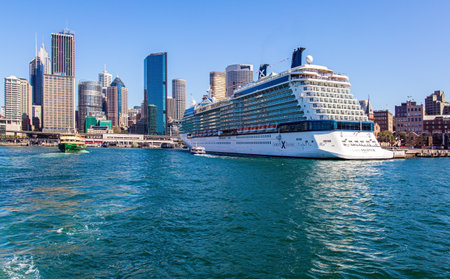 SYDNEY, AUSTRALIA - MARCH 30, 2018: The famous Sydney Harbor. Boat trip on a tourist boat along the picturesque shores of the port. Huge white ocean liner at the quays.のeditorial素材