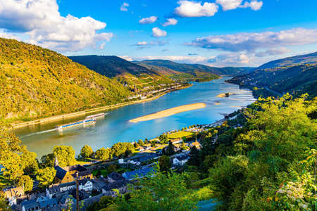 Rhine Castles: Journey into the German Middle Ages. The hills are home to the well groomed vineyards. Romantic castles on the banks of the Rhine. Sunsetの写真素材