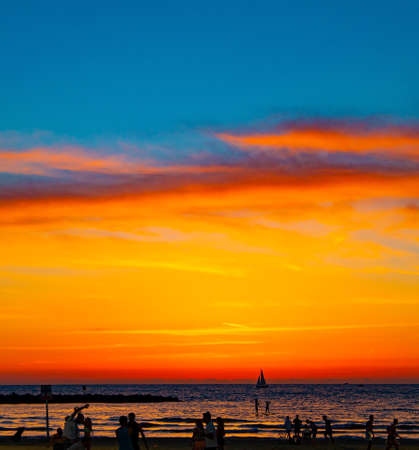 Magnificent hot sunset on the Mediterranean Sea. Tel Aviv, israel. Sea waves glow with reflected lightの写真素材