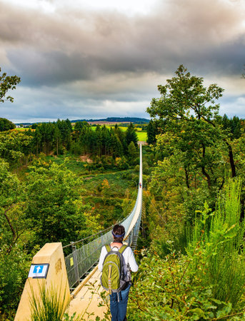An elegant woman with a backpack admires the beautiful landscape. The magnificent Geyerlei is the...