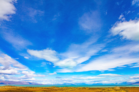 Whimsical clouds over the lake. The road to the famous Mount Fitzroy. Argentine Patagonia. The...