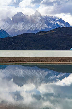 Majestic snow-capped mountains are reflected in the lake. The Gray Glacier. The famous Torres del Paine park. Patagonia, Chile.の写真素材