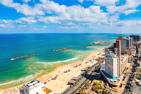 TEL AVIV, ISRAEL - JUNE 3, 2021: Tel Aviv on a  summer day. Photo taken from aerial view. Skyscraper hotels on the waterfront, azure Mediterranean Sea, beautiful beaches.のeditorial素材