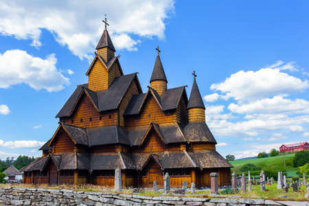 Travel to Norway in summer. Stave Church crowned with crosses. The Stave Church is crowned with crosses. The oldest and most beautiful church in Norwayの写真素材