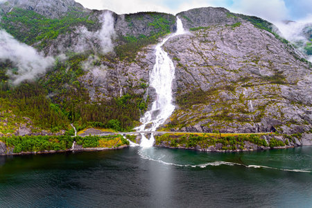 Langfossen cascade waterfall on the Vaule river. Western Norway. Passes through the highway. The photo was taken with a drone. Summer cold and rainy dayの写真素材