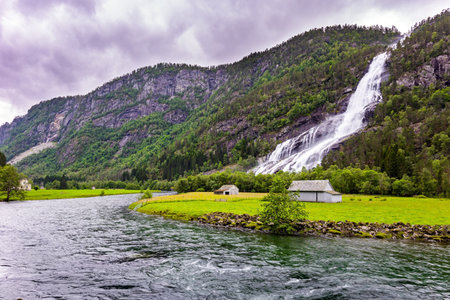 Huge powerful waterfal Vidfossen. Scenic road in the mountains of Western Norway. Beginning of the Hardangerfjord. Scandinavia. Summer, Julyの写真素材