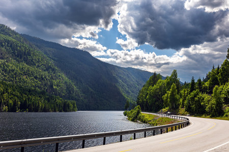 Scenic road to Roldal. Beautiful lake among the green flowering hills. Journey to Western Norway. Warm cloudy July dayの写真素材