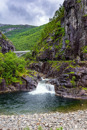 Small waterfall in a stream. Road to Roldal. Scenic landscape in Western Norway. Summer trip to the north of Europe. Cold and rainy day.の写真素材