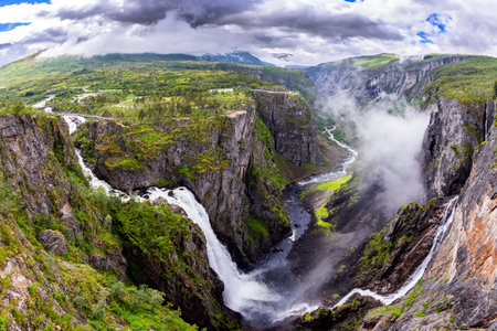 Norway. Voringsfossen is one of the most famous Norwegian cascading waterfalls. The waterfall falls into picturesque gorge. Photo taken with a fisheye lensの写真素材