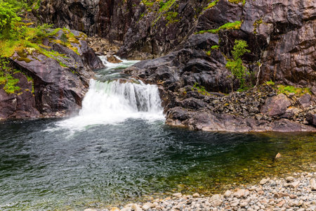 Small waterfall in a stream. Road to Roldal. Summer trip to the north of Europe. Cold and rainy day. Scenic landscape in Western Norway.の写真素材