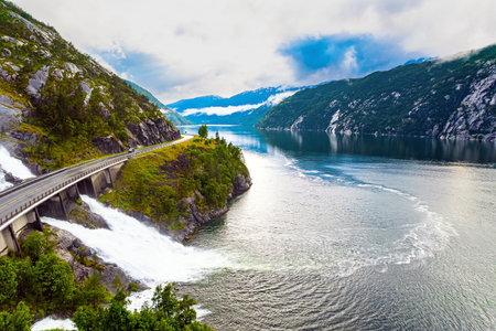 Langfossen cascade waterfall on the Vaule river. Passes through the highway. Summer cold and rainy day. The photo was taken with a drone. Western Norway.の写真素材