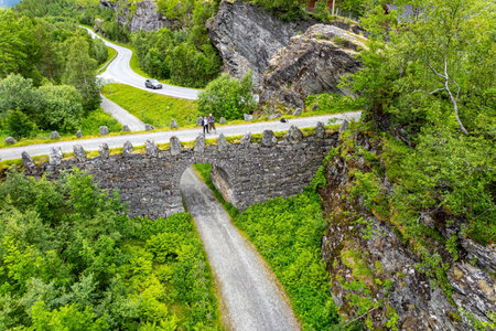 Picturesque mountain road - serpentine. Exciting adventure in the north of Norway. Picturesque green country in summer. The photo was taken from a drone.の写真素材