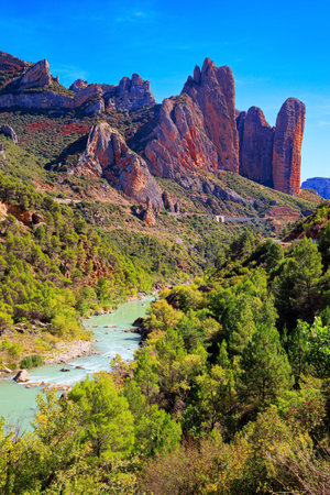 The picturesque river Gallego flows through the gorge. The magnificent Mallets of Riglos. Beautiful rocks - part of the foothills of the Pyrenees. Romantic trip to Spain. Aragon.の写真素材