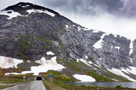 Lake Djupvatnet. Huge cold snowfields and sharp stone placers. Summer trip to Norway. Cold July in Northern Europeの写真素材