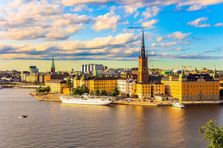 Golden sunset light illuminates the ancient buildings of the city.  Hot summer day in Stockholm. Stockholm is the capital of Sweden.の写真素材