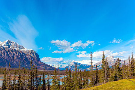 Journey Magical Rocky Mountains. Picturesque Abraham Lake with blue water. Sunny day in October. Gorgeous Canadian autumn.の写真素材