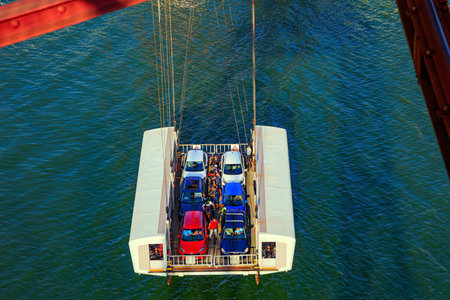 Flying ferry across the Nervion River. The gondola accommodates cars, motorcycles and people. Biscay Suspension Bridge in Portugalete. Bilbao, Basque country.の写真素材
