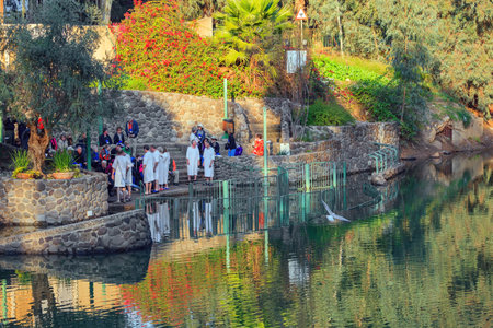 YARDENIT, ISRAEL - JANUARY 21, 2012: Group of believers in white baptismal shirts. Symbolic rite of baptism for believers. The exit point of the Jordan River from Lake Tiberias is Yardenitのeditorial素材