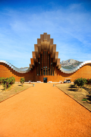 The magnificent architecture of Bodegas Ysios blends in beautifully with the surrounding landscape and rows of vineyards. Laguardia. The sunset. Impressive landscape. Spanish autumnの写真素材