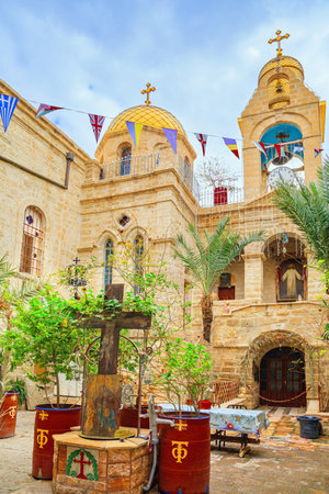Monastery of St. Gerasim of Jordan. Small courtyard. The male monastery of the Jerusalem Orthodox Church in the Judean Desert. The bell tower topped with a gilded Orthodox cross.の写真素材