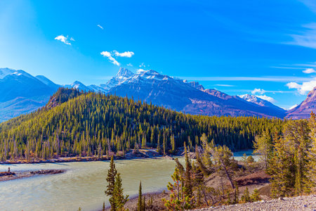Rocky Mountains of Canada. Mountain peaks covered with snow and glaciers. This artificial Abraham lake. Dense evergreen forests surround the lakeの写真素材