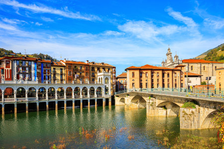 Basque country. Beautiful  bridge was built across the river. The picturesque center of Tolosa is built on the banks of the Oria River. Embankment of the Oria Riverの写真素材