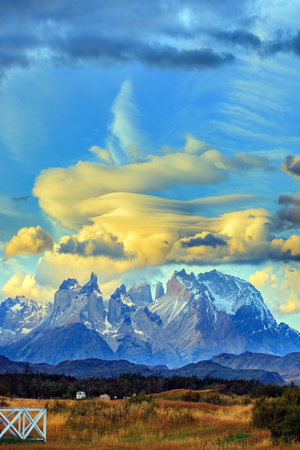 The massive granite towers of Cuernos del Paine. Incredible clouds illuminated by the sunset. Chile. Torres del Paine Park.の写真素材