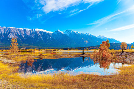 The artificial lake Abraham. Smooth water reflects the Rocky Mountains. Gorgeous Canadian autumn. Sunny day in October.の写真素材