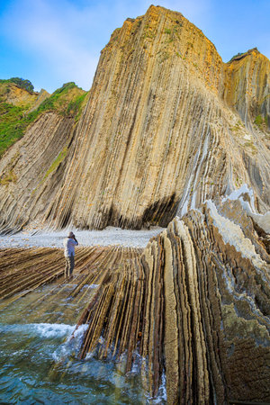 Tourist photographs Playa Zumaya. Low tide in the Atlantic. Flysch - unique landscape of underwater...