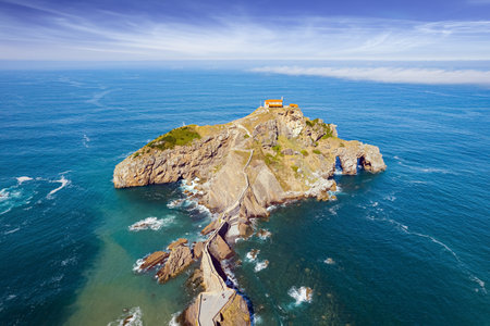 The island Gastelugache connected to the mainland by a bridge and a winding staircase. Photo taken from a drone. The most extraordinary coast of Spain. The Bay of Biscay, Basque Country.の写真素材
