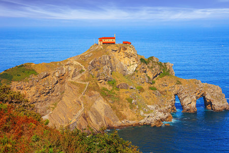 The island Gastelugache is connected to the mainland by bridge and winding staircase. The Bay of Biscay. The chapel of San Juan de Gaztelugatxe was built on the island in the 10th century.の写真素材