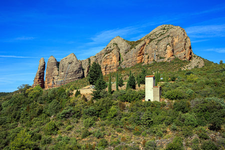 Aguero village at the foot of the dangerous and magnificent Mallos cliffs. Province of Huesca, Aragon. Romantic trip to northern Spain. The magical nature of Spain.の写真素材
