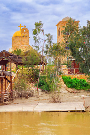 The Jordan River - state border between Israel and Jordan. Yellow water of the wide Jordan River. Place of the Baptism of Jesus Christ in Israel - Qasr el Yahud.の写真素材