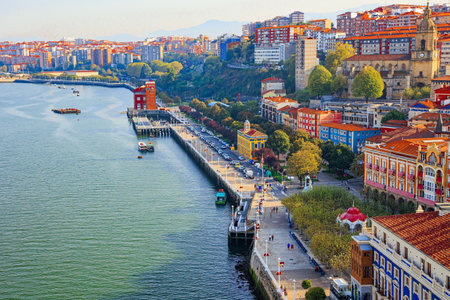 Flying ferry across the Nervion River. Photo taken from the ferry. European exotic. Colorful city with unusual architecture and rich history. Portugalete, the district of Bilbao, Basque country.のeditorial素材