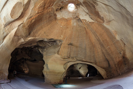 Bell Caves - quarries of the 7th century AD. The walls of the cave amaze with a variety of rocks. The park Beit Guvrin, Israel. Sunbeam in the ceiling illuminates the vaults of the cave.のeditorial素材