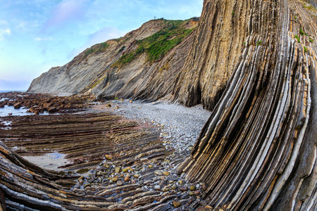 Playa Zumaya. Flysch - unique landscape of underwater rocks exposed at low tide. The most stunning beach in the Basque Country - Itsurun. Coast of the Bay of Biscay, Atlantic.の写真素材