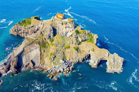 The island Gastelugache connected to the mainland by a bridge and a winding staircase. Atlantic coast. Magical unique landscape. Photo taken from a droneの写真素材