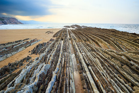 Basque country. Magical unique landscape. Flysch - unique landscape of underwater rocks exposed at low tide. The most unusual beach in the Basque Country - Itsurunの写真素材