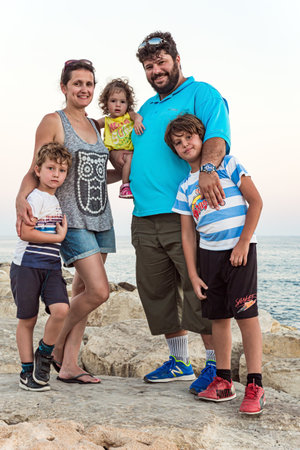 Happy family. Family vacation in a hotel on the Greek island of Cyprus. Cozy beach on the Mediterranean coast.の写真素材