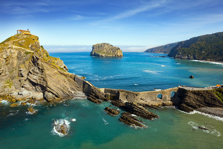 The most extraordinary coast of Spain. The island Gastelugache connected to the mainland by a bridge and a winding staircase. The Bay of Biscay, Basque Country. Photo taken from a droneの写真素材