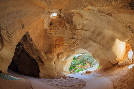 The famous underground national park Beit Guvrin, Israel. Bell caves - quarries of the 7th century AD. Sunbeam in the ceiling picturesquely illuminates the vaults of the cave.の写真素材