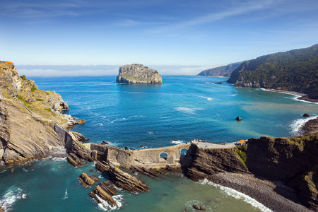 The coast of Spain. The island Gastelugache connected to the mainland by a bridge and a winding staircase. The Bay of Biscay, Basque Country. Photo taken from a droneの写真素材