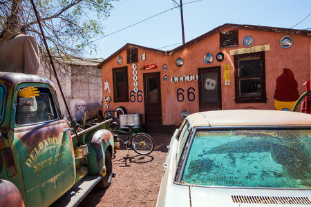 ROUTE 66, ARIZONA, USA - OCTOBER 8, 2009: Historic Highway 66 is a scenic popular road in the United States. Very old car is parked on the side of the road.のeditorial素材